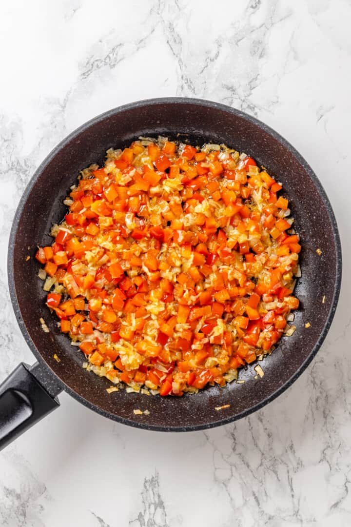 This easy ratatouille recipe boasts colourful layers of eggplant, squash, and tomato in a rich, tangy tomato sauce with delicate herb oil. Sautéing onion, garlic, and bell pepper in olive oil.