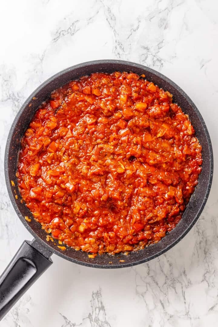This easy ratatouille recipe boasts colourful layers of eggplant, squash, and tomato in a rich, tangy tomato sauce with delicate herb oil. Adding tomato paste and tomato sauce to sautéed aromatics in a skillet.