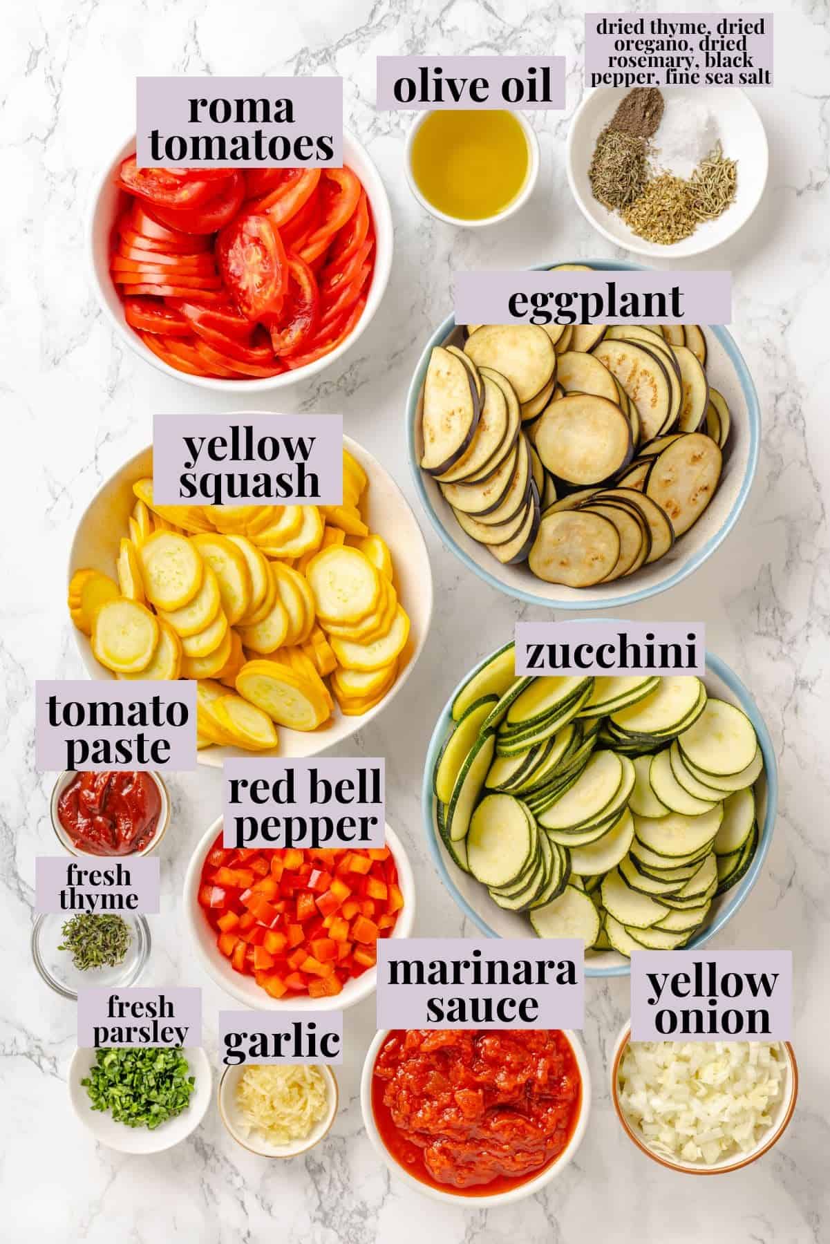 This easy ratatouille recipe boasts colourful layers of eggplant, squash, and tomato in a rich, tangy tomato sauce with delicate herb oil. Labeled ingredients for easy ratatouille recipe.
