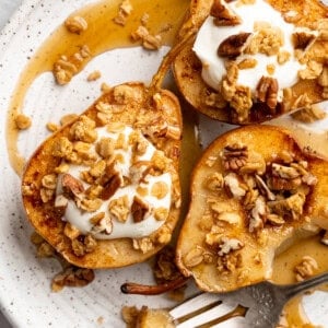 Cinnamon baked pears topped with coconut cream and granola.