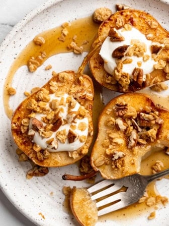 Cinnamon baked pears topped with coconut cream and granola.