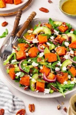 A plate full of roasted sweet potato arugula salad.