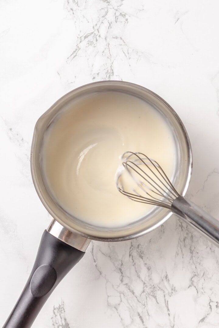 Fabulously fluffy, filled with soft, cinnamony apples, and topped with cream cheese frosting, you need these apple cinnamon rolls now. Cooking a mixture of flour, soy milk, and water for tangzhong.
