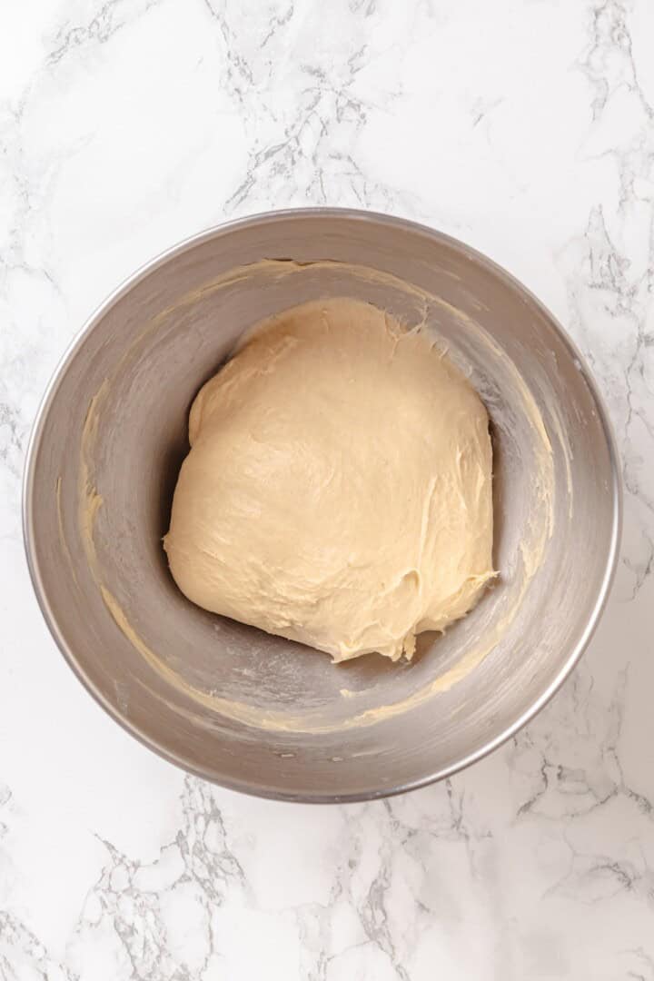Fabulously fluffy, filled with soft, cinnamony apples, and topped with cream cheese frosting, you need these apple cinnamon rolls now. Kneaded dough for cinnamon rolls in a bowl.