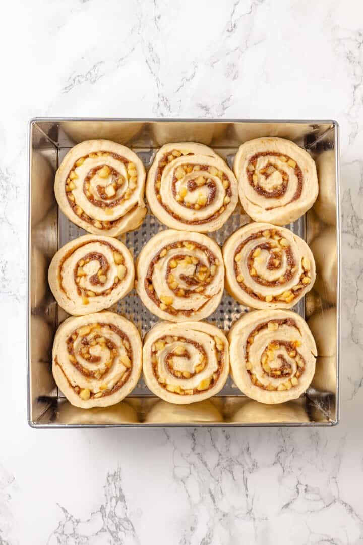 Fabulously fluffy, filled with soft, cinnamony apples, and topped with cream cheese frosting, you need these apple cinnamon rolls now. Fully risen apple cinnamon rolls ready to bake.