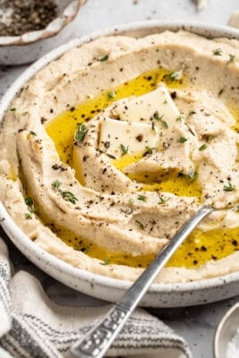 A bowl of vegan mashed cauliflower topped with olive oil.